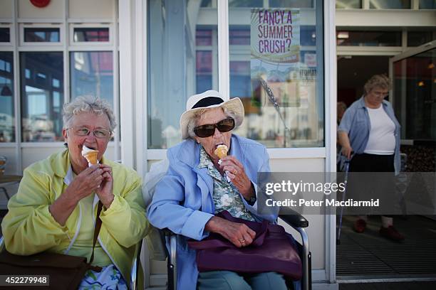 Elderly holidaymakers enjoy a traditional ice cream cone on the South Beach on July 17, 2014 in Lowestoft, England. The Met Office has issued a...