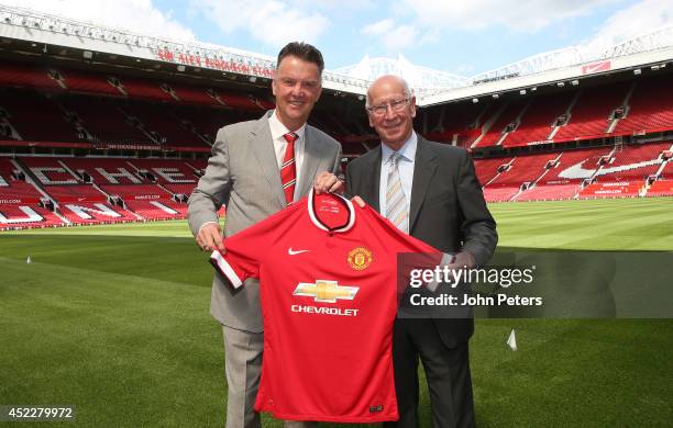 New manager Louis van Gaal of Manchester United poses with club legend Sir Bobby Charlton after a press conference to announce his arrival at Old...