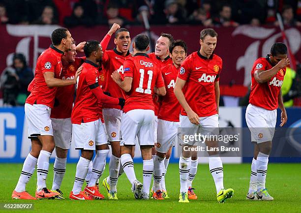 Chris Smalling and Ryan Giggs of Manchester United celebrate with team mates after Emir Spahic of Bayer Leverkusen scored an own goal to make it 2-0...