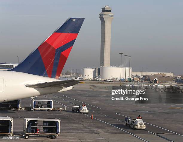 Ground crew personnel service Delta planes at the Salt Lake City international Airport on November 27, 2013 in Salt Lake City, Utah. A wintry storm...