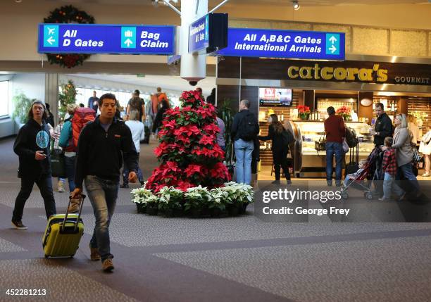 Holiday travelers make their way through the Salt Lake City international Airport on November 27, 2013 in Salt Lake City, Utah. A wintry storm system...