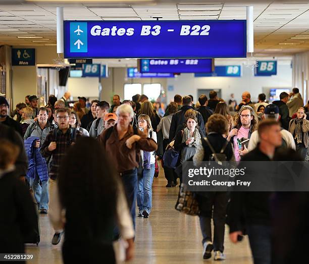 Holiday travelers make their way through the Salt Lake City international Airport on November 27, 2013 in Salt Lake City, Utah. A wintry storm system...