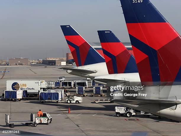 Ground crew personnel service Delta planes at the Salt Lake City international Airport on November 27, 2013 in Salt Lake City, Utah. A wintry storm...