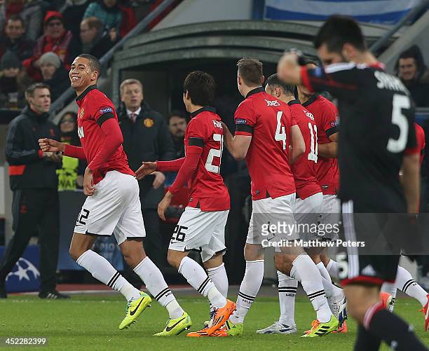 Chris Smalling of Manchester United celebrates Emir Spahic of Bayer Leverkusen scoring an own goal during the UEFA Champions League Group A match...