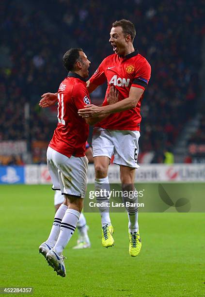 Jonny Evans of Manchester United celebrates with Ryan Giggs of Manchester United after scoring their third goal during the UEFA Champions League...