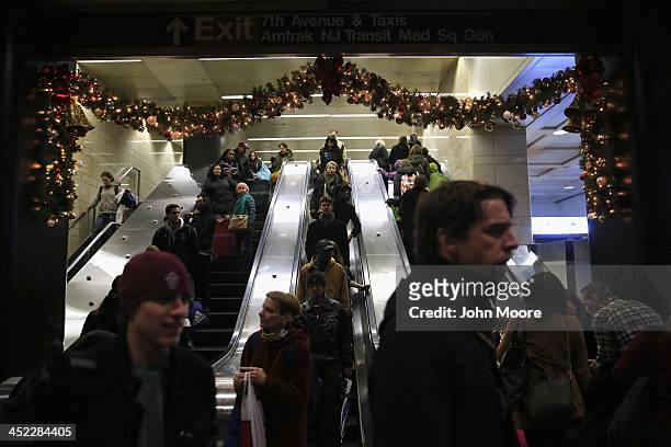 People descend into Pennsylvania Station to board trains on the busiest travel day of the year November 27, 2013 in New York City. Even on an average...