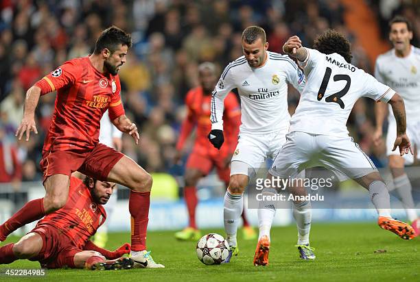 Galatasaray's Gokhan Zan vies for the ball with Real Madrid's Marcelo during the UEFA Champions League football match between Real Madrid vs...