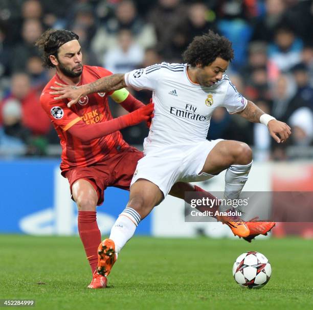 Galatasaray's Gokhan Zan vies with Real Madrid's Marcelo during the UEFA Champions League football match between Real Madrid vs Galatasaray at the...