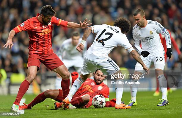 Galatasaray's Gokhan Zan vies with Real Madrid's Marcelo during the UEFA Champions League football match between Real Madrid vs Galatasaray at the...