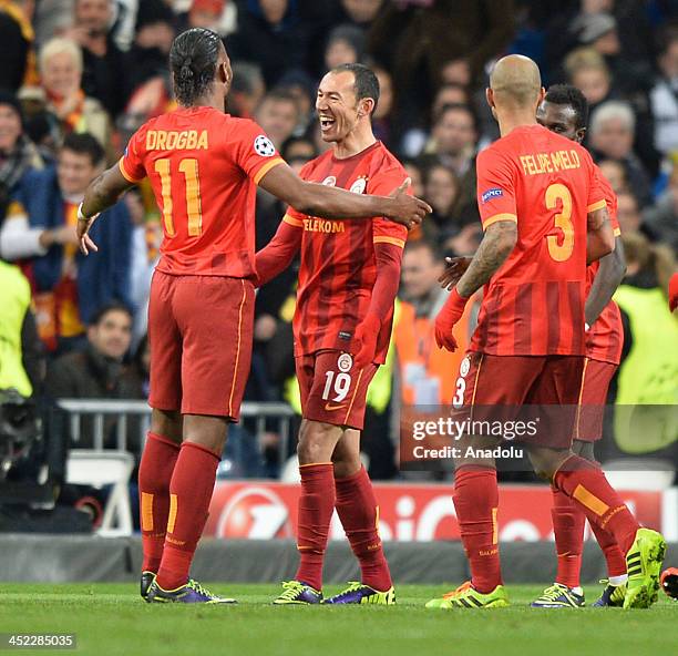 Galatasaray's Umut Bulut celebrates after scoring their team first goal with Didier Drogba and Felipe Melo during the UEFA Champions League football...