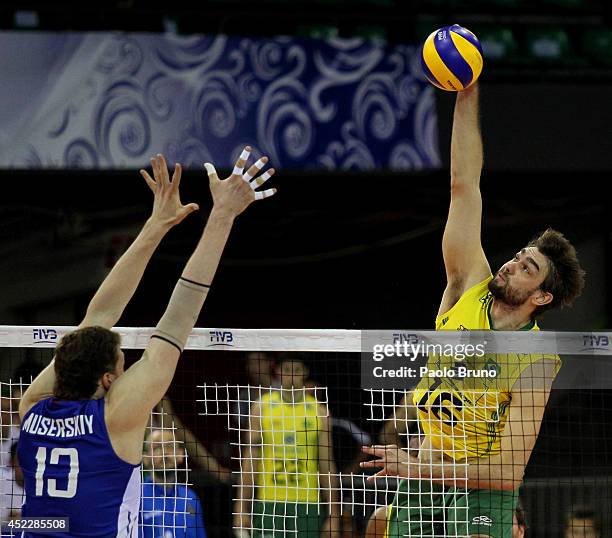 Lucas Saatkamp of Brazil spikes the ball as Dmitriy Muserskiy of Russia blocks during the FIVB World League Final Six match between Russia and Brazil...