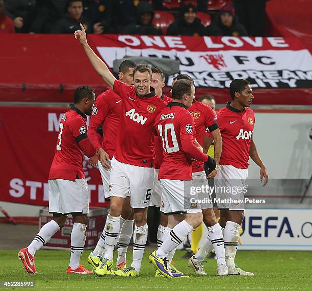 Jonny Evans of Manchester United celebrates scoring their third goal during the UEFA Champions League Group A match between Bayer Leverkusen and...