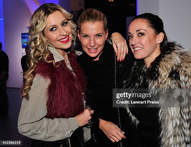 Verena Kerth , Giulia Siegel and Melanie Fischer pose during the photography exhibition "Bitte recht freundlich" of artist Niels Ruf on November 27,...