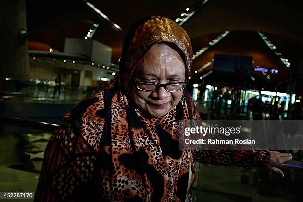 Family member cries as she receives the news of the ill fated flight MH17 on the phone on July 18, 2014 in Kuala Lumpur, Malaysia. Malaysia Airlines...