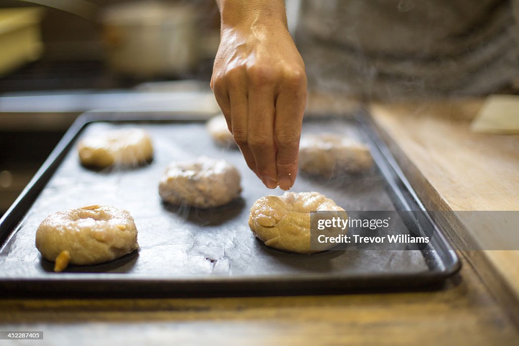 Bagels being prepared for baking in a bakery