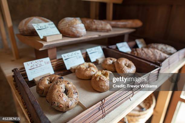stone oven baked bread on display - bakery display stock-fotos und bilder