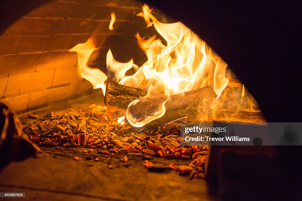 A fire inside a stone oven
