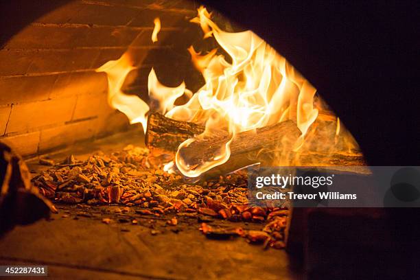 a fire inside a stone oven - wood burning stove stock pictures, royalty-free photos & images