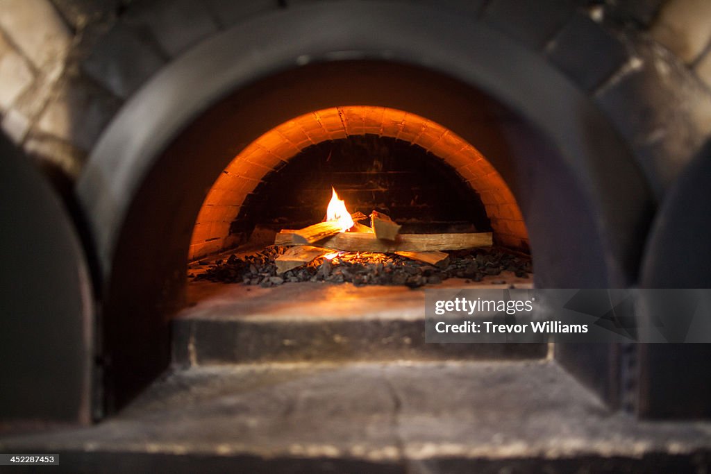 A small flame in a stone oven