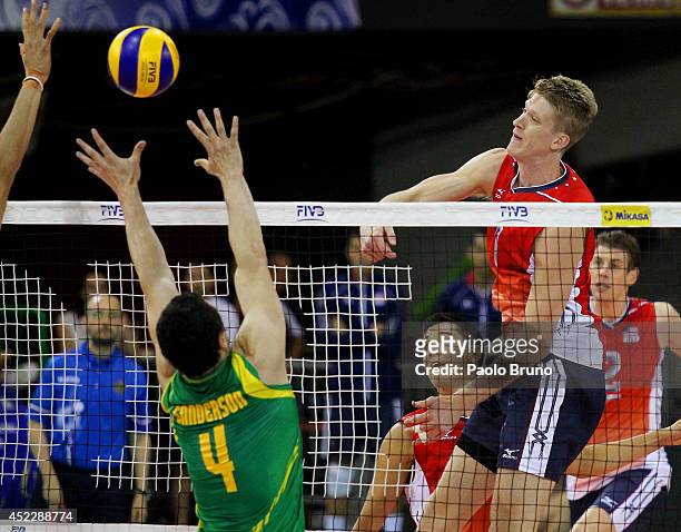 Holt Maxwell of United States spikes the ball as Paul Sanderson of Australia block during the FIVB World League Final Six match between United States...
