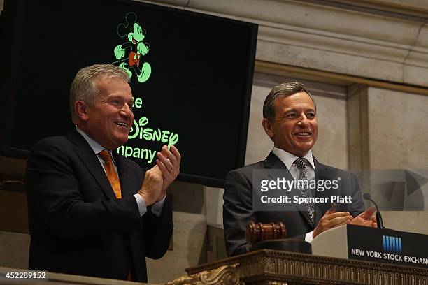 Disney CEO Bob Iger rings the Closing Bell at the New York Stock Exchange as CEO of the New York Stock Exchange Duncan Niederauer watches on July 17,...