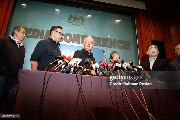 Malaysian Prime Minister Najib Razak pauses before he leaves the press conference after delivering a statement regarding the ill fated flight MH17 on...