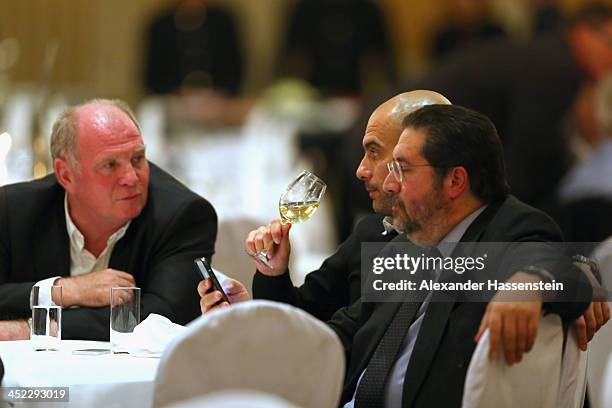 Uli Hoeness, President of Bayern Muenchen talks to head coach Josep Guardiola and Giovanni Branchini during the Champions Dinner at RitzCarlon Hotel...