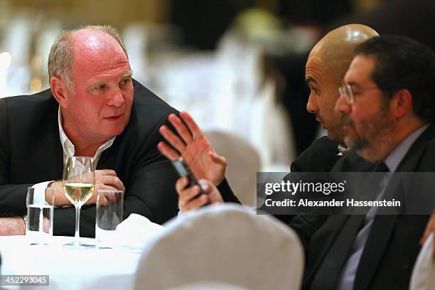 Head coach Josep Guardiola of Bayern Muenchen talks to President Uli Hoeness and Giovanni Branchini during the Champions Dinner at RitzCarlon Hotel...