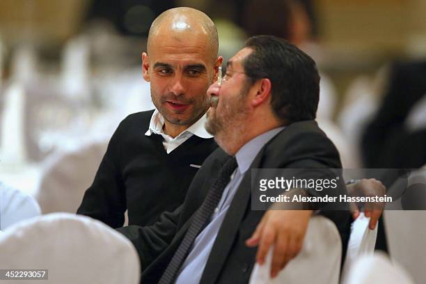 Head coach Josep Guardiola of Bayern Muenchen talks Giovanni Branchini during the Champions Dinner at RitzCarlon Hotel Moscow after winning UEFA...