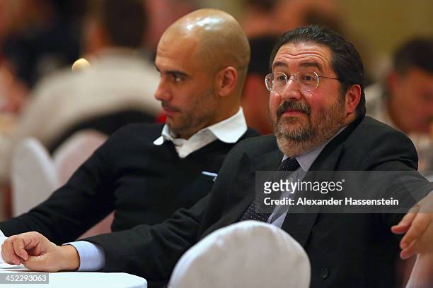 Head coach Josep Guardiola of Bayern Muenchen looks on with Giovanni Branchini during the Champions Dinner at RitzCarlon Hotel Moscow after winning...