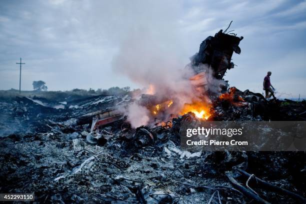 Debris from Malaysia Airlines Flight 17 is shown smouldering in a field July 17, 2014 in Grabovo, Ukraine near the Russian border. Flight 17, on its...