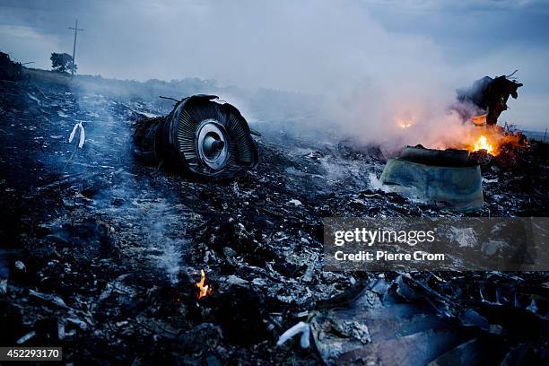 Debris from Malaysia Airlines Flight 17 is shown smouldering in a field July 17, 2014 in Grabovo, Ukraine near the Russian border. Flight 17, on its...