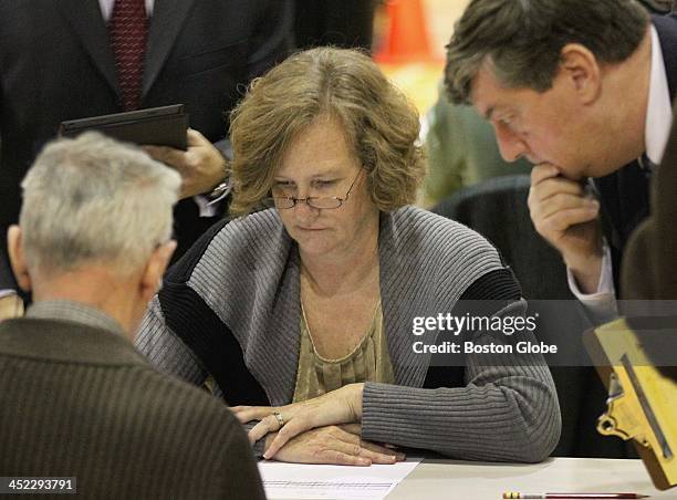 Monitor, right, got a closer look as votes were tallied during a manual recount of Lawrence's mayoral race at the South Lawrence East Educational...