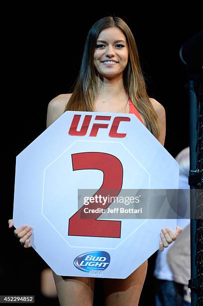 Octagon Girl Vanessa Hanson signals the start of round two between Lucas Martins and Alex White in their featherweight bout during the UFC Fight...