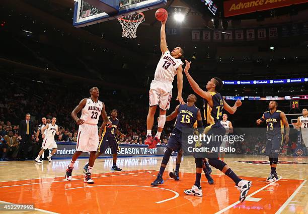 Nick Johnson of the Arizona Wildcats scores against the Drexel Dragons during their Semi Final game of the NIT Season Tip Off at Madison Square...