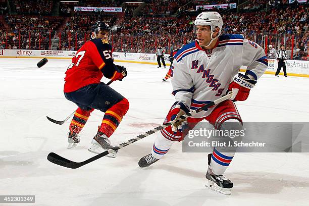 Dan Girardi of the New York Rangers keeps his eye on the puck against Marcel Goc of the Florida Panthers at the BB&T Center on November 27, 2013 in...