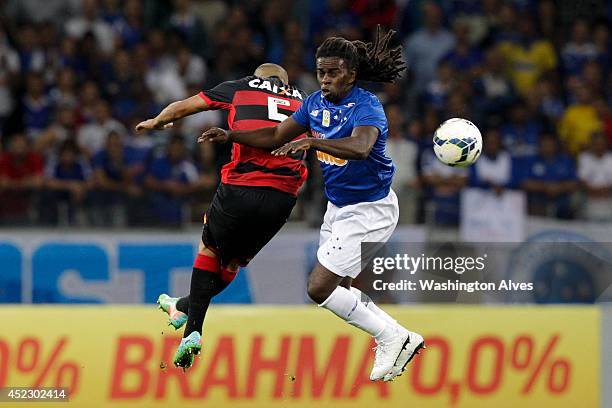 Tinga of Cruzeiro struggles for the ball with Adriano of Vitoria during a match between Cruzeiro and Vitoria as part of Brasileirao Series A 2014 at...