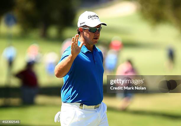 Scott Laycock of Australia acknowledges the crowd after a putt during day one of the 2013 Australian Open at Royal Sydney Golf Club on November 28,...