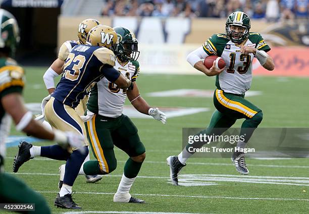 July 17: Edmonton Eskimos' quarterback Mike Reilly runs the ball himself against the Winnipeg Blue Bombers' during first half CFL Football at...