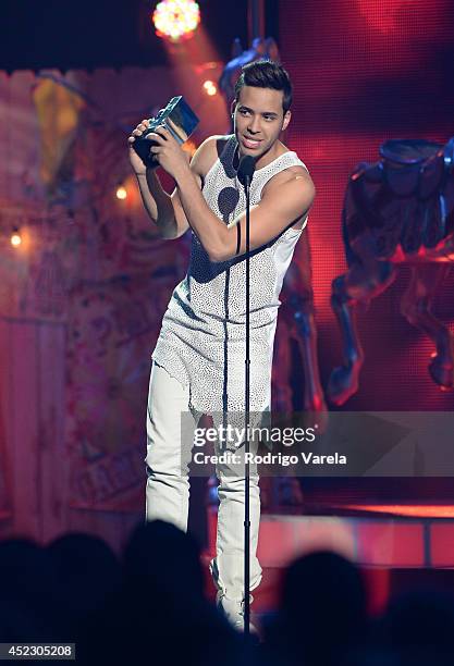 Prince Royce accepts an award onstage during the Premios Juventud 2014 at The BankUnited Center on July 17, 2014 in Coral Gables, Florida.