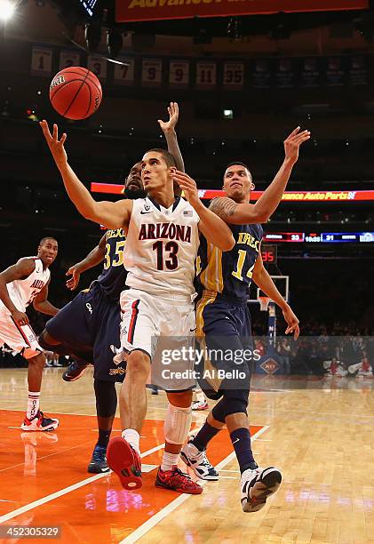 Nick Johnson of the Arizona Wildcats grabs a rebound against Damion Lee of the Drexel Dragons during their Semi Final game of the NIT Season Tip Off...