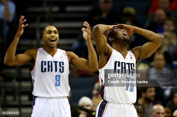 Teammates Kemba Walker and Gerald Henderson of the Charlotte Bobcats react after a call during their game against the Indiana Pacers at Time Warner...