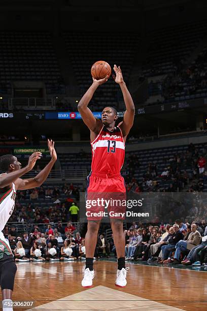 Kevin Seraphin of the Washington Wizards shoots against Ekpe Udoh of the Milwaukee Bucks on November 27, 2013 at the BMO Harris Bradley Center in...