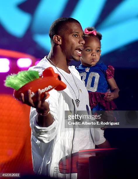 Player Victor Cruz with daughter Kennedy Cruz onstage during Nickelodeon Kids' Choice Sports Awards 2014 at UCLA's Pauley Pavilion on July 17, 2014...