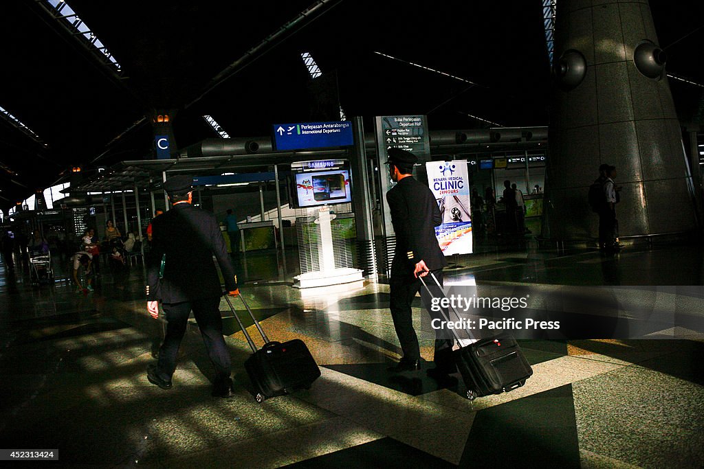 Malaysia Airlines cabin crew walk at Kuala Lumpur...