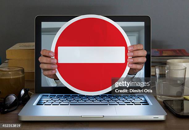 no entry sign appearing out of laptop computer - no entry stock-fotos und bilder