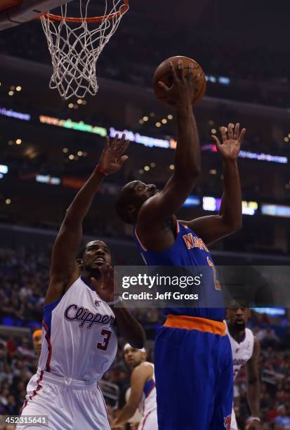 Raymond Felton of the New York Knicks drives past Chris Paul of the Los Angeles Clippers for a reverse layup in the first half at Staples Center on...