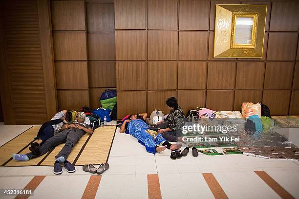 Protesters rest as anti-government protesters occupy the Government Complex on November 28, 2013 in Bangkok, Thailand. Protests began in Bangkok on...