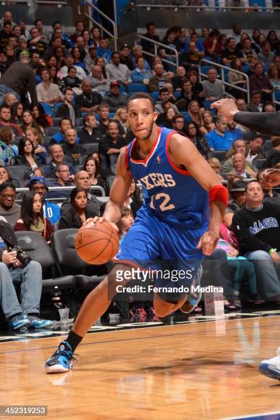 Evan Turner of the Philadelphia 76ers dribbles to the basket against the Orlando Magic during the game on November 27, 2013 at Amway Center in...
