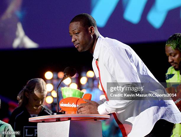 Player Dwyane Wade accepts the King of Swag Award onstage during the Nickelodeon Kids' Choice Sports Awards 2014 at UCLA's Pauley Pavilion on July...